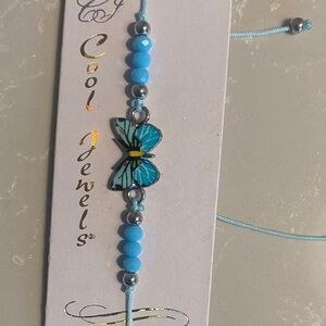Blue Butterfly Bracelet on beaded adjustable bolo type cord. NWT
